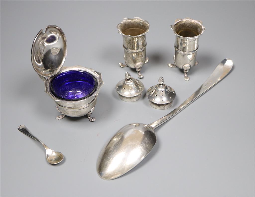 An Edwardian silver three piece condiment set with spoon, Birmingham, 1903 and a George III silver table spoon, London, 1784,